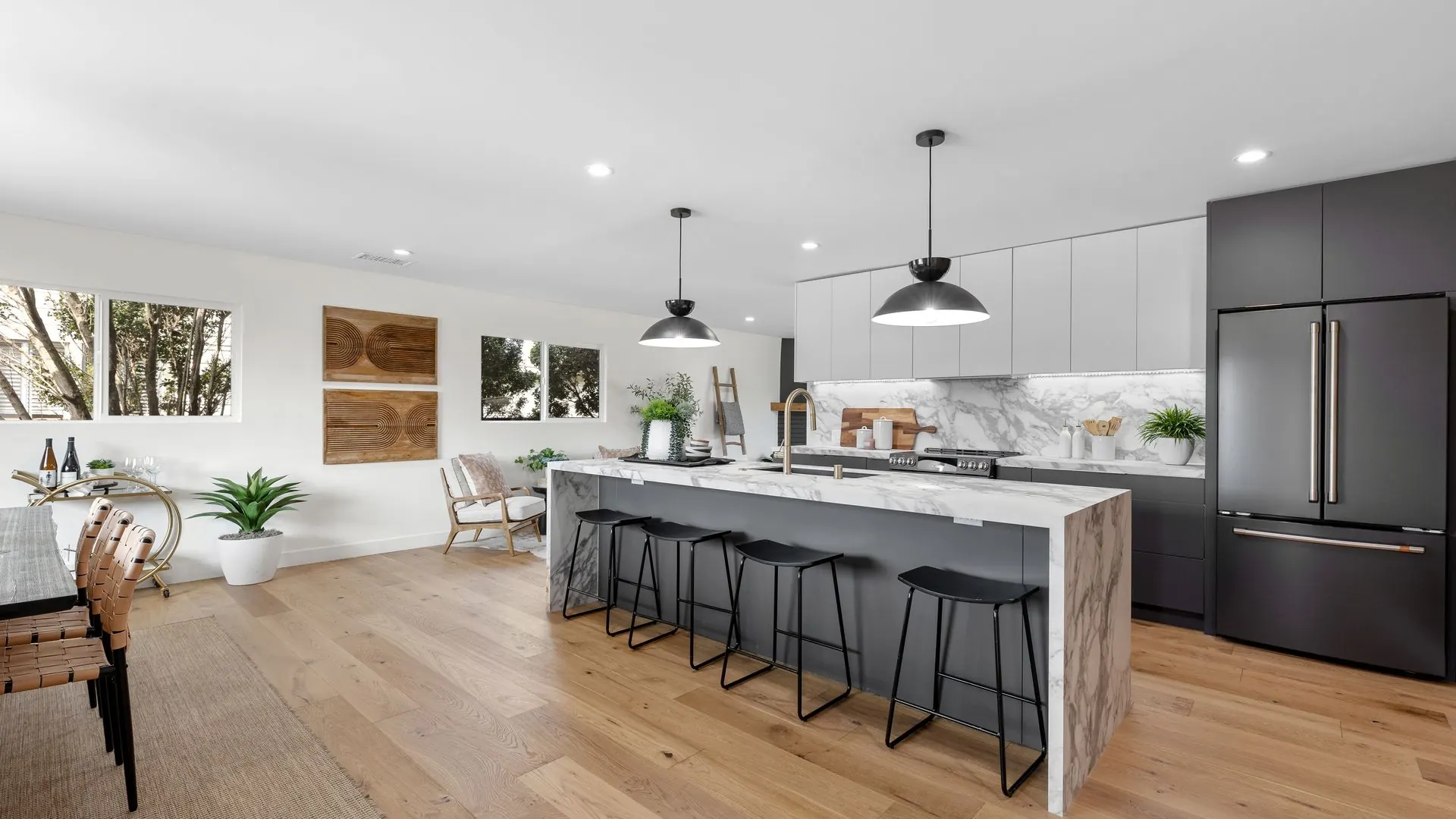 Bright modern kitchen remodel with island and barstools by Girl Flip Construction in Los Angeles