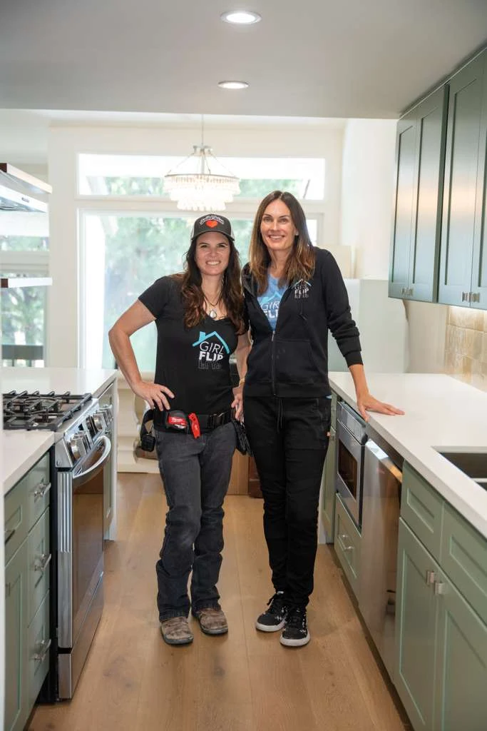 Erica Anenberg and Beth Benson of Girl Flip Construction standing in a finished kitchen